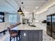 Open-concept kitchen with white cabinets, a large island with seating, and sleek stainless steel appliances at 3240 Songbird Cir, Harmony, FL 34773