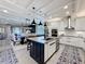 Modern kitchen featuring white cabinets, a large center island, and pendant lighting, perfect for entertaining at 3240 Songbird Cir, Harmony, FL 34773