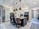 Open concept kitchen with white cabinets, island, pendant lights, and stainless steel appliances at 3240 Songbird Cir, Harmony, FL 34773
