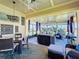 Enjoy this screened lanai with a ceiling fan, stylish decor, and a beautiful view of the outdoors at 3240 Songbird Cir, Harmony, FL 34773