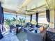 Enjoy the view from this peaceful screened lanai with comfortable seating and an oversized ceiling fan at 3240 Songbird Cir, Harmony, FL 34773