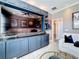 Living room featuring a custom blue entertainment center, cozy seating, and elegant decor at 3240 Songbird Cir, Harmony, FL 34773
