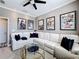 Stylish living room featuring a comfortable sectional sofa, movie posters, and round glass coffee tables at 3240 Songbird Cir, Harmony, FL 34773