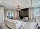 Modern living room with a fireplace, comfortable seating, and stylish decor, and coffered ceiling at 3240 Songbird Cir, Harmony, FL 34773