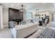 Open-concept living space with fireplace, neutral decor, and view into the dining area and modern kitchen at 3240 Songbird Cir, Harmony, FL 34773
