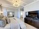Spacious main bedroom with a gray upholstered king bed and a TV stand at 3240 Songbird Cir, Harmony, FL 34773