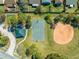 Aerial view of community park including basketball court, baseball diamond, and shaded picnic area at 3303 Ann Arbor Ct, St Cloud, FL 34772