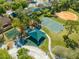 A beautiful aerial view of a neighborhood park featuring a playground, a basketball court, and an open green space at 3303 Ann Arbor Ct, St Cloud, FL 34772