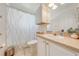 Bright bathroom with vanity, tile floors, and a shower/tub combo with patterned shower curtain at 3303 Ann Arbor Ct, St Cloud, FL 34772