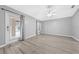 Spacious bedroom featuring wood floors, neutral paint, and a glass door to the screened-in patio at 3303 Ann Arbor Ct, St Cloud, FL 34772