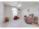 Comfortable bedroom with laminate flooring, and an arched window at 3303 Ann Arbor Ct, St Cloud, FL 34772