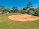 Park featuring a baseball diamond, basketball court, picnic shelter, and mature trees at 3303 Ann Arbor Ct, St Cloud, FL 34772