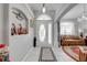 Inviting entryway featuring tile floors, a decorative niche with violins, and natural light filtering through the front door at 3303 Ann Arbor Ct, St Cloud, FL 34772