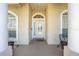 Covered front porch featuring arched windows, decorative columns, and a welcoming entrance at 3303 Ann Arbor Ct, St Cloud, FL 34772