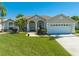 Charming single-story home with well-manicured lawn, arched entryway and two-car garage at 3303 Ann Arbor Ct, St Cloud, FL 34772