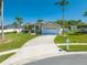 Beautiful single-story home featuring a lush lawn, long driveway, and attached two-car garage at 3303 Ann Arbor Ct, St Cloud, FL 34772