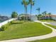 Inviting home with a manicured lawn and mature palm trees lining the winding driveway at 3303 Ann Arbor Ct, St Cloud, FL 34772