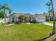Well-manicured lawn and landscaping enhance this charming single-story home with an attached two car garage at 3303 Ann Arbor Ct, St Cloud, FL 34772