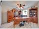 Spacious home office with custom wooden desk, cabinets, and hardwood flooring at 3303 Ann Arbor Ct, St Cloud, FL 34772