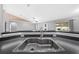 Kitchen sink and countertop open to the living room and view to outside at 3303 Ann Arbor Ct, St Cloud, FL 34772