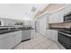 Modern kitchen features stainless steel appliances, white cabinets, and tile flooring at 3303 Ann Arbor Ct, St Cloud, FL 34772