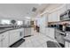 Well-lit kitchen with stainless steel appliances, white cabinetry, and tile flooring offers functionality and style at 3303 Ann Arbor Ct, St Cloud, FL 34772