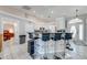 Modern kitchen with a breakfast bar, pendant lighting, and white cabinetry, ready for culinary adventures at 3303 Ann Arbor Ct, St Cloud, FL 34772