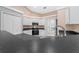 Bright kitchen featuring white cabinets, black countertops, stainless steel appliances and tile flooring at 3303 Ann Arbor Ct, St Cloud, FL 34772
