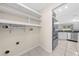 The laundry room provides ample shelving and connections, conveniently located near the kitchen at 3303 Ann Arbor Ct, St Cloud, FL 34772