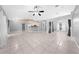 Bright, open-concept living area with tile flooring, a view of the kitchen, and natural light at 3303 Ann Arbor Ct, St Cloud, FL 34772