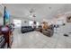 Open-concept living area boasts ample seating, neutral tones, and seamlessly connects to the dining area at 3303 Ann Arbor Ct, St Cloud, FL 34772