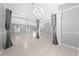 Open-concept living room with tile flooring, decorative columns, and ample natural light at 3303 Ann Arbor Ct, St Cloud, FL 34772