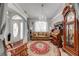 Cozy living room featuring a decorative rug, chandelier, and large front door with glass at 3303 Ann Arbor Ct, St Cloud, FL 34772