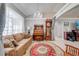 Living room featuring a plush brown sofa, elegant chandelier, and a decorative rug at 3303 Ann Arbor Ct, St Cloud, FL 34772