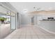 Bright living space with tile flooring, a vaulted ceiling, and sliding glass doors to the pool area at 3303 Ann Arbor Ct, St Cloud, FL 34772
