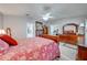 Main bedroom featuring a ceiling fan and a view into the main bathroom at 3303 Ann Arbor Ct, St Cloud, FL 34772