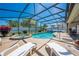 Inviting screened-in pool area with a hot tub and lounge chairs at 3303 Ann Arbor Ct, St Cloud, FL 34772