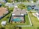 Aerial view of house with screened-in pool, backyard, and nearby neighborhood at 3303 Ann Arbor Ct, St Cloud, FL 34772