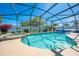 Screened-in pool and hot tub with clear blue water and patio area for relaxing and entertaining by the pool at 3303 Ann Arbor Ct, St Cloud, FL 34772