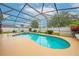 A beautiful screened-in pool with a spa and lush landscaping creating a serene outdoor oasis at 3303 Ann Arbor Ct, St Cloud, FL 34772
