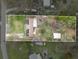 An aerial view displays the home with solar panels, surrounded by lush greenery and a defined property line at 425 S 12Th St, Lake Wales, FL 33853