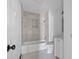 Updated bathroom with a shower-tub combo, tile walls, and modern fixtures at 425 S 12Th St, Lake Wales, FL 33853