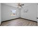 Bright bedroom with wood-look floors, ceiling fan, and natural light from two windows at 425 S 12Th St, Lake Wales, FL 33853