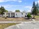A charming single-story home featuring a covered front porch and mature landscaping at 425 S 12Th St, Lake Wales, FL 33853