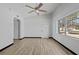 A bright, minimalist living room with a ceiling fan and large window at 425 S 12Th St, Lake Wales, FL 33853