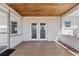 Covered patio area with tile flooring, providing an ideal space for outdoor seating at 425 S 12Th St, Lake Wales, FL 33853
