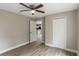 Bedroom features wood-look floors, closet, neutral paint, and a modern ceiling fan at 429 Lark Ct, Poinciana, FL 34759