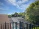 Backyard view from an elevated position looking down onto a screened pool and heavily wooded surroundings at 4602 Cumbrian Lakes Dr, Kissimmee, FL 34746