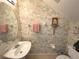Cozy bathroom with unique patterned wallpaper, oval mirror, and a pedestal sink at 4602 Cumbrian Lakes Dr, Kissimmee, FL 34746