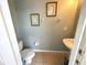 Small bathroom featuring pedestal sink, commode, and framed wall art at 4602 Cumbrian Lakes Dr, Kissimmee, FL 34746